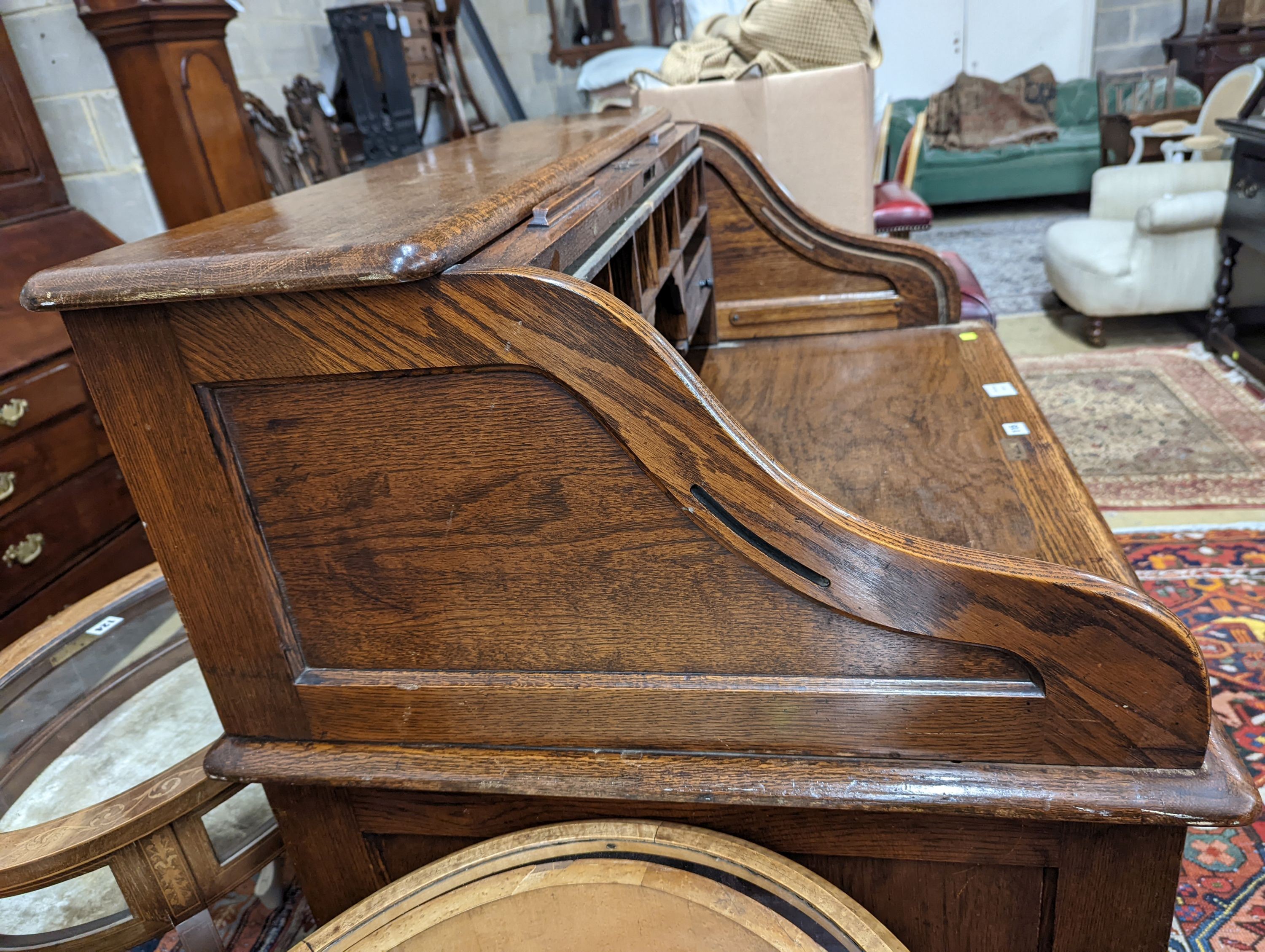 An early 20th century oak roll top desk with 'S' shaped tambour, width 106cm, depth 75cm, height 119cm
